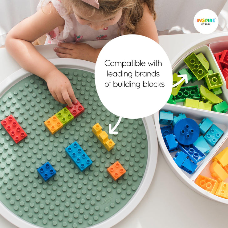 Child placing a building block on to the building block mat