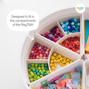 Two storage inserts placed within PlayTRAY compartments holding a range of craft resources