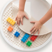 Building block mat being folded over by a child's hands to show both sides